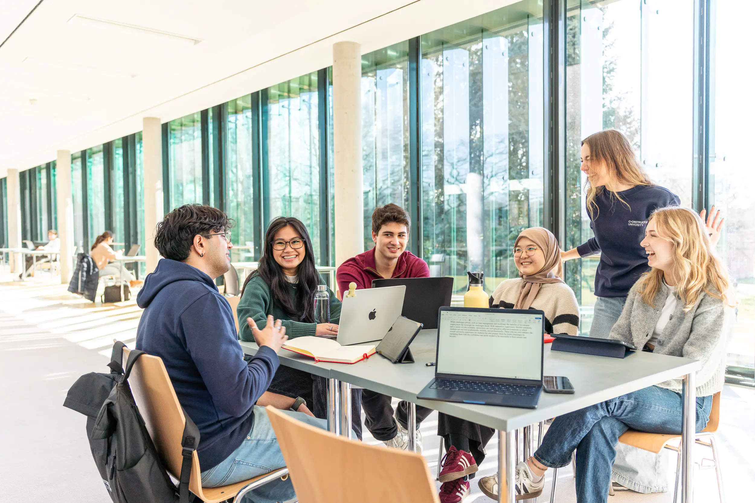 Students learning together in the IRC Foyer